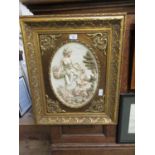 An ornate gilt framed relief moulded panel depicting a lady an child