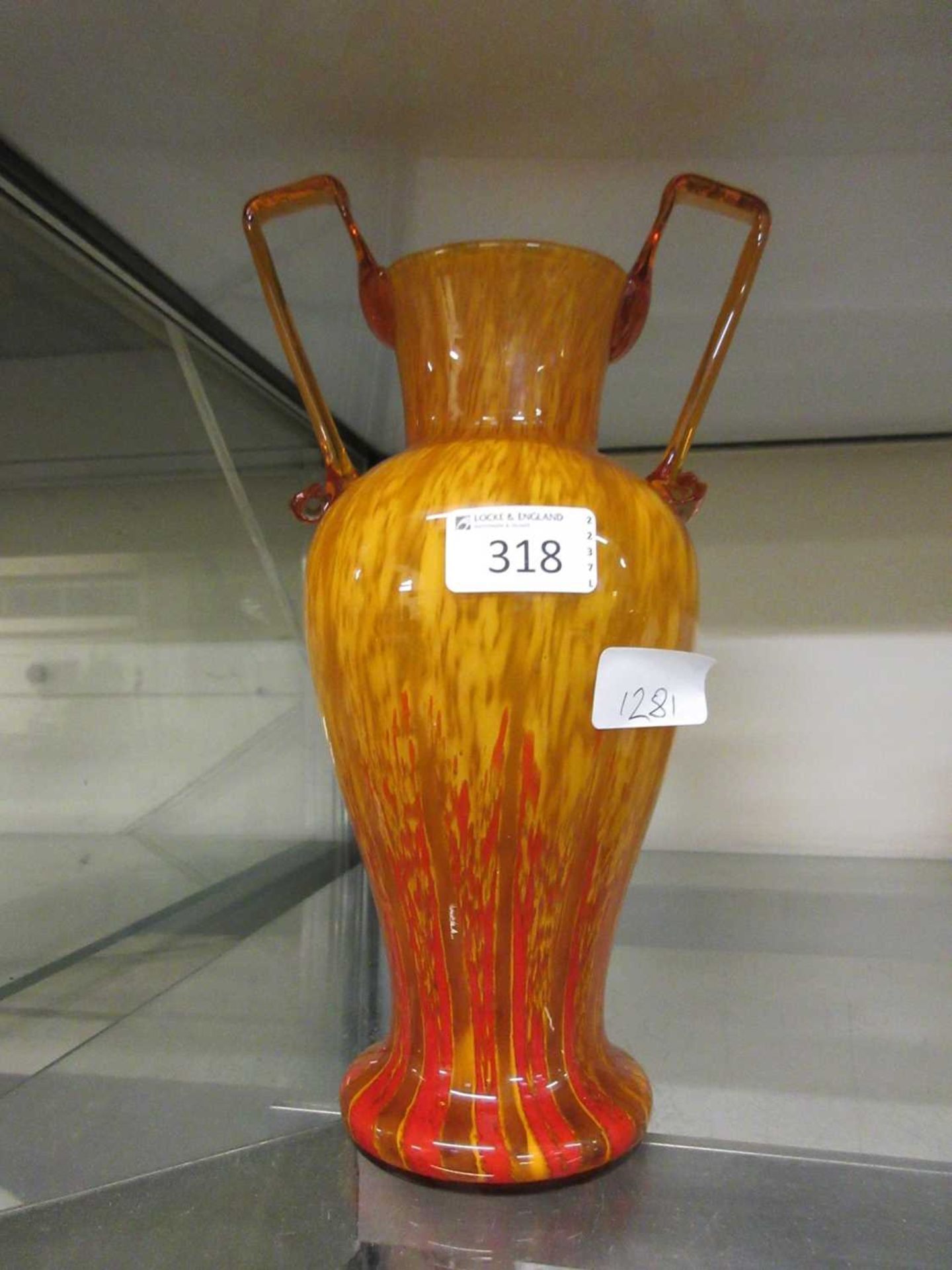 An orange twin handled possible Murano glass vase