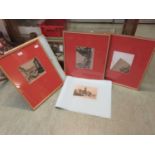A set of three framed and glazed monochrome etchings of village scenes along with a collection of