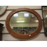 A carved pine oval framed mirror