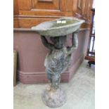 A lead bird bath with putto column