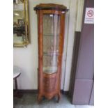A reproduction Italian inlaid glazed display cabinet with serpentine glazed front door with original