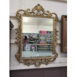 An ornate gilt framed bevel glass mirror