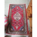 A rectangular red ground rug