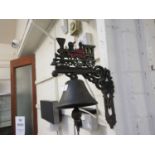 A reproduction cast metal wall mounted bell with steam locomotive design
