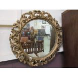 An ornate gilt framed circular mirror