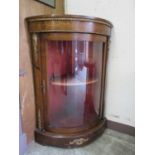 A late Victorian Regency style bow front mahogany inlaid glazed cabinet