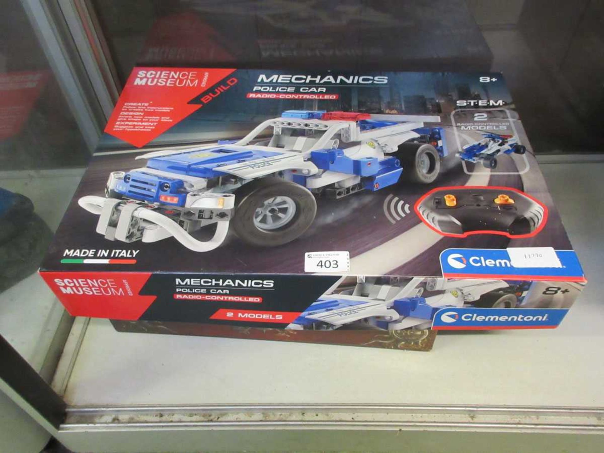 A boxed Mechanics police car together with a boxed Warhammer 'Age Of Reckoning' figure