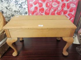 A stripped wooden bench with cabriole supports