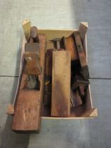 A wooden box containing block planes, moulding planes, etc