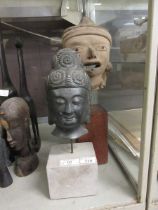 A hollow bronze south Asian mask of Buddha, on a square marble base, 36.5cm overall; and a pre-