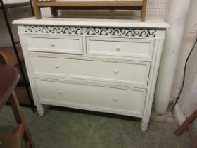 A cream painted chest of two short over two long drawers