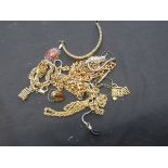 A bag containing yellow metal chains, etc