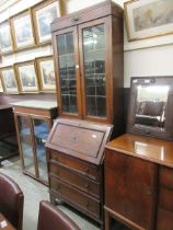 A mid-20th century oak bureau bookcase having a leaded glaze two door top with four drawers above