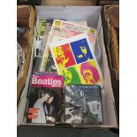 A tray of pop memorabilia to include books on The Beatles, advertising poster, etc No apparent