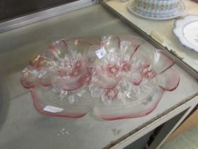 A pink glass tray along with two connected pink glass bowls, all with floral decoration