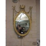 A reproduction gilt painted decorative wall mirror