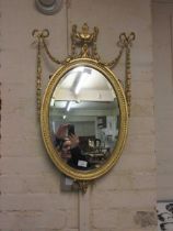 A reproduction gilt painted decorative wall mirror
