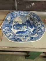 A large octagonal blue and white ceramic meat plate with classical town scene decoration