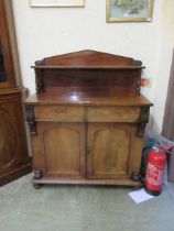 An early 19th century mahogany chiffonier, with shaped gallery back with turned supports, over two