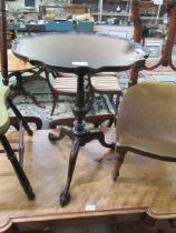A reproduction mahogany pedestal table with ball and claw feet