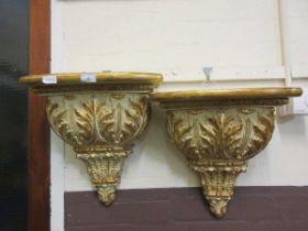 A pair of gilt painted wall mounted wall shelves