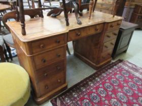 A Victorian mahogany twin pedestal desk, the top having three drawers, the pedestals each having