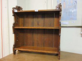 A set of stained pine wall mounted book shelves