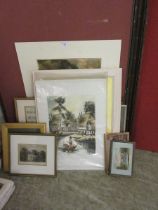 A selection of framed and unframed mounted artworks on various subjects