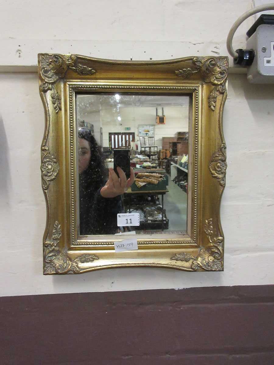 A gilt framed wall mirror