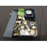 A biscuit tin containing a quantity of watches by various makers