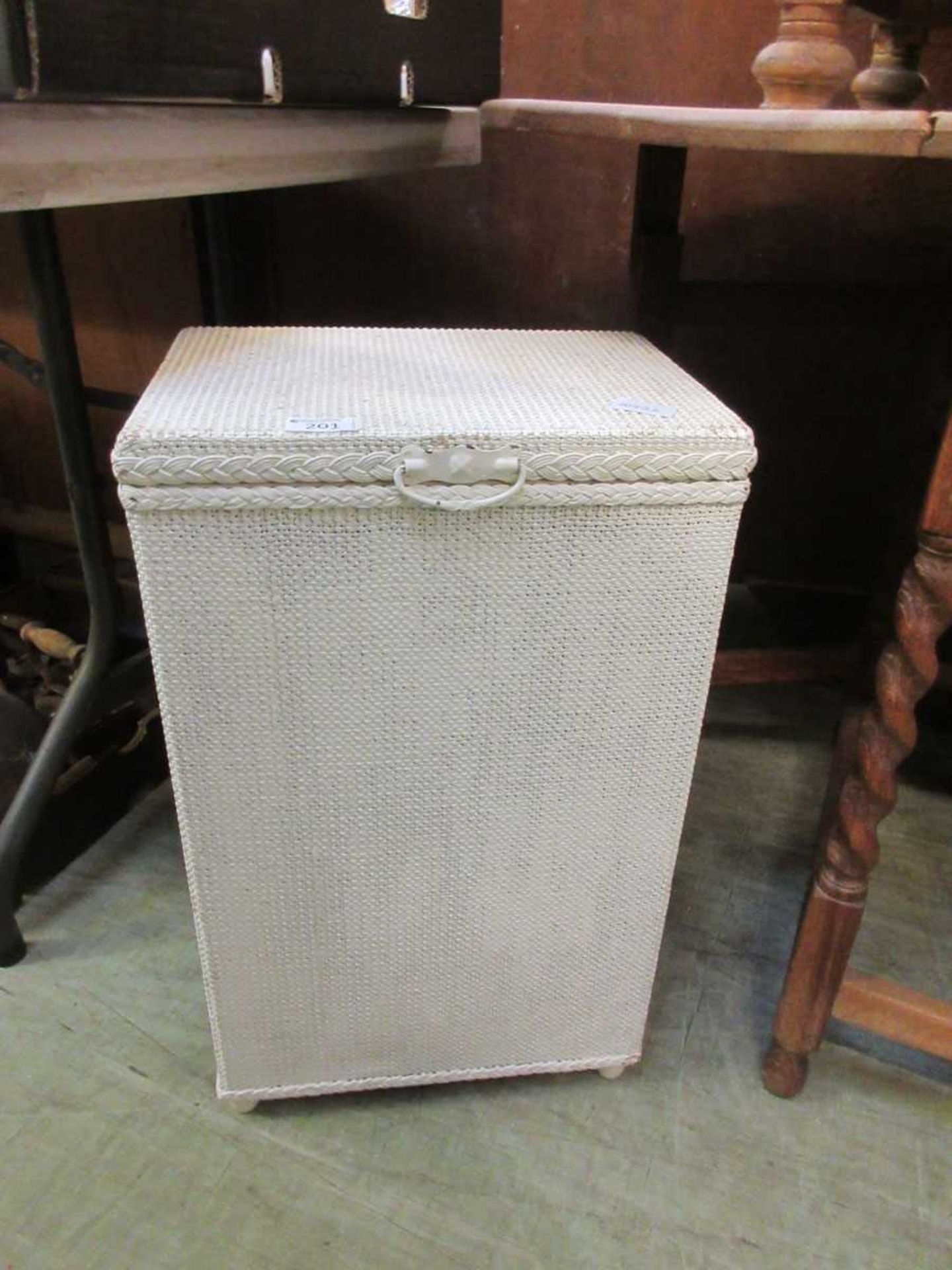 A white painted soft wicker linen basket