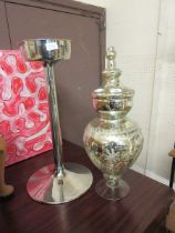 A silvered glass lidded vessel together with a stainless steel champagne bucket stand