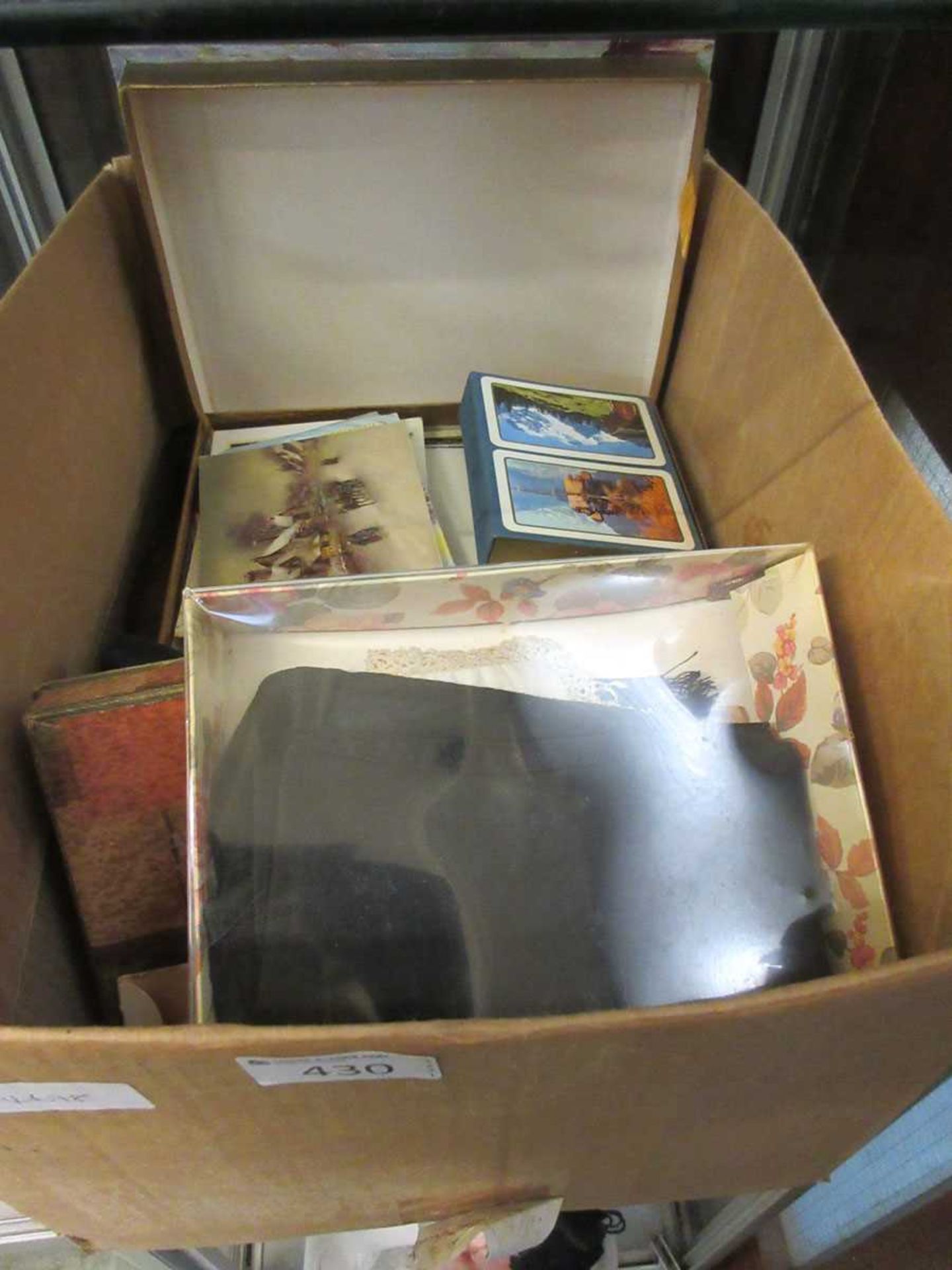 A carton containing a quantity of postcards, silks, etc