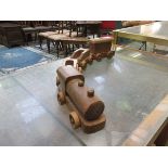 A hand crafted wooden train with carriages