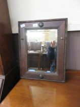 An oak framed bevel glass wall mirror