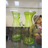 A pair of modern green glass water jugs