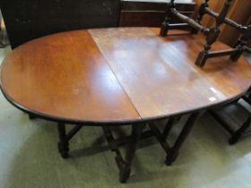 An oak oval drop leaf gate leg dining table