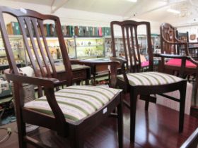 A pair of modern mahogany open arm dining chairs