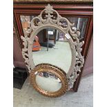 A collection of four various framed mirrors