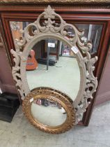 A collection of four various framed mirrors
