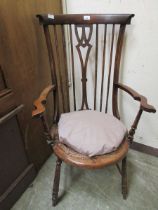 An early 20th century mahogany open arm chair