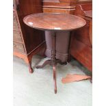 An 18th century mahogany and oak tilt top tripod table, the dish top on a turned column and three