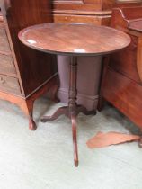 An 18th century mahogany and oak tilt top tripod table, the dish top on a turned column and three