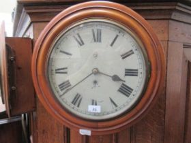 A circular mahogany framed wall clock