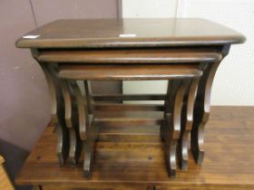 A nest of three Ercol style dark elm occasional tables