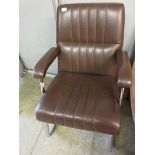 A chromium framed and brown vinyl office chair