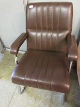 A chromium framed and brown vinyl office chair