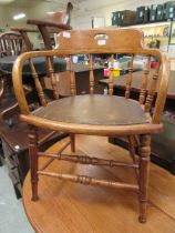 An oak stick back office chair on turned supports Chip to frame near one arm. Minor knocks and