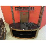 A modern mid-20th century style dark wood and glass TV stand